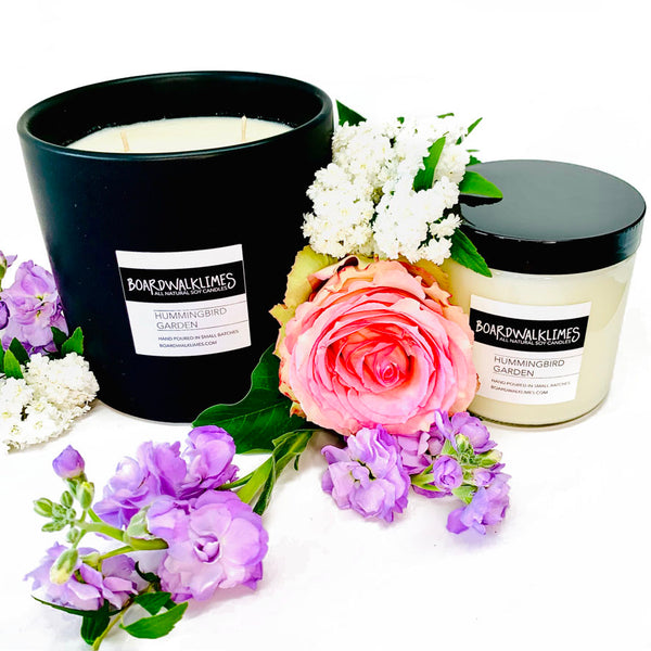 Floral soy candles with rose, gardenia, and lilac fragrances wrapped in gorgeous cork sleeves with shiny gold inlays and rose gold button studs for the best summer candles