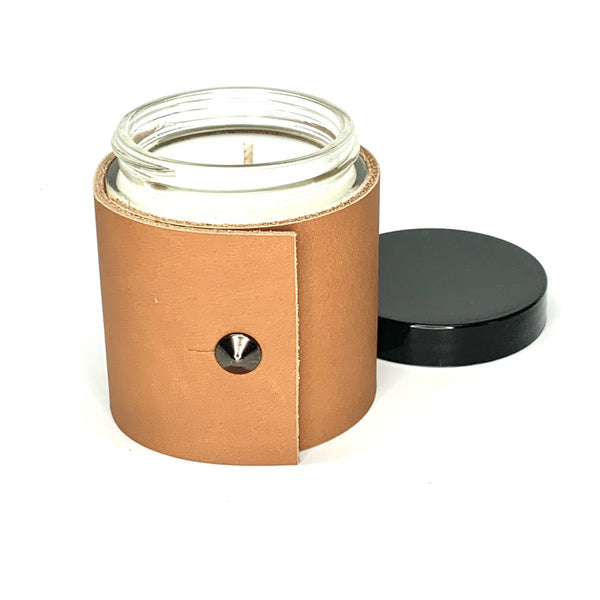 4 oz soy candle with caramel colored fine leather sleeve with oil rubbed black stud