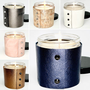 3 Luxury soy candles in the best fragrances wrapped in metallic blue leather and black studs, fine white leather with shiny gold studs, and elegant cork with gold inlays and shiny gold button studs