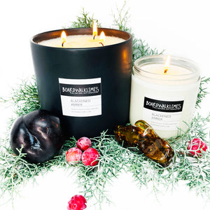 Luxury soy candles and essential oil diffuser oils in rich evergreen and sweet amber and plum fragrances