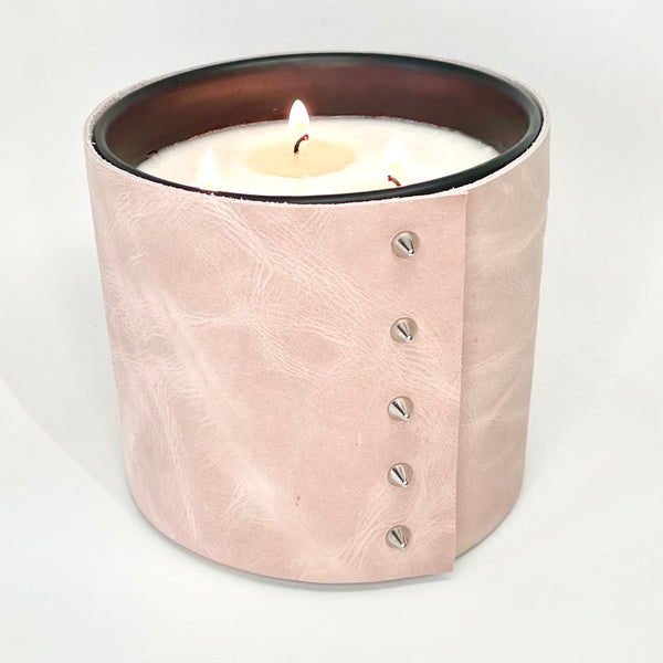 3-wick large luxury candle wrapped in a blush pink leather with 5 shiny cone shaped silver studs