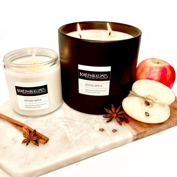 Luxury all scented soy candle with apples and cinnamon in a clear glass jar and a large coffee table size candle with fall scented apples and cinnamon