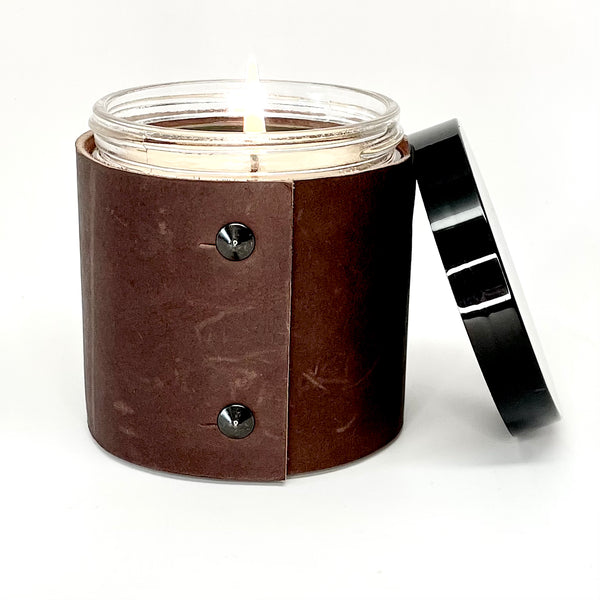 soy candle wrapped in rugged brown leather with 2 oil rubbed black studs