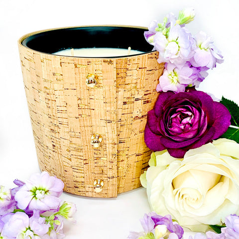 Luxury large soy candles filled with beautiful floral fragrances of rose, gardenia, and lilac wrapped in a cork sleeves with brilliant gold inlays and 3 rose gold button studs