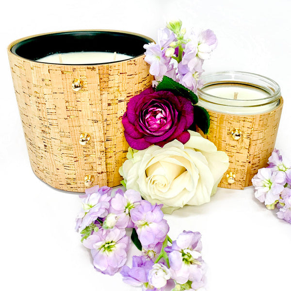Floral soy candles with rose, gardenia, and lilac fragrances wrapped in gorgeous cork sleeves with shiny gold inlays and rose gold button studs for the best summer candles