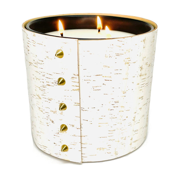 An all natural luxury soy candle wrapped in white cork with and 5 gold cone shaped studs