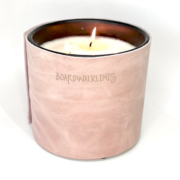 3-wick large luxury candle wrapped in a blush pink leather with 5 shiny cone shaped silver studs