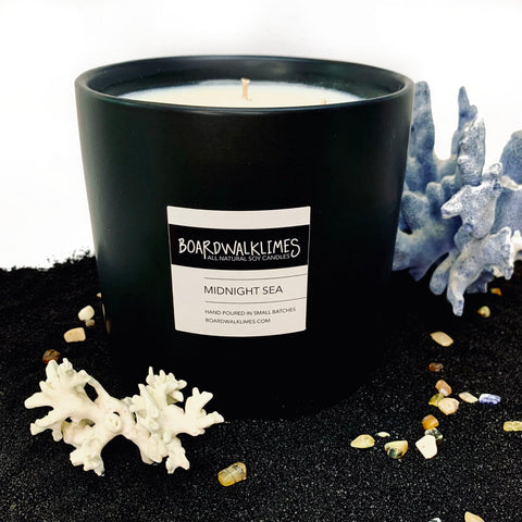 Large luxury 3-wick soy candle with seal salt and plum beach scented fragrances in a handmade black ceramic vase