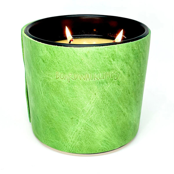 large all natural soy candle with 3 wicks is wrapped in a spring green leather with 5 black cone shaped studs