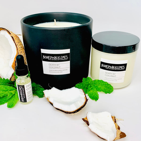 Smooth coconut with a hint of mint soy candle in a glass jar with a shiny black lid, and a large 3-wick luxury coconut candle in a handmade black ceramic vase, and essential oil coconut diffuser oil in a glass bottle with a black dropper lid