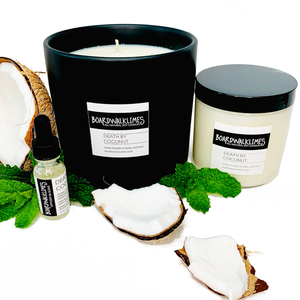 Smooth coconut with a hint of mint soy candle in a glass jar with a shiny black lid, and a large 3-wick luxury coconut candle in a handmade black ceramic vase, and essential oil coconut diffuser oil in a glass bottle with a black dropper lid