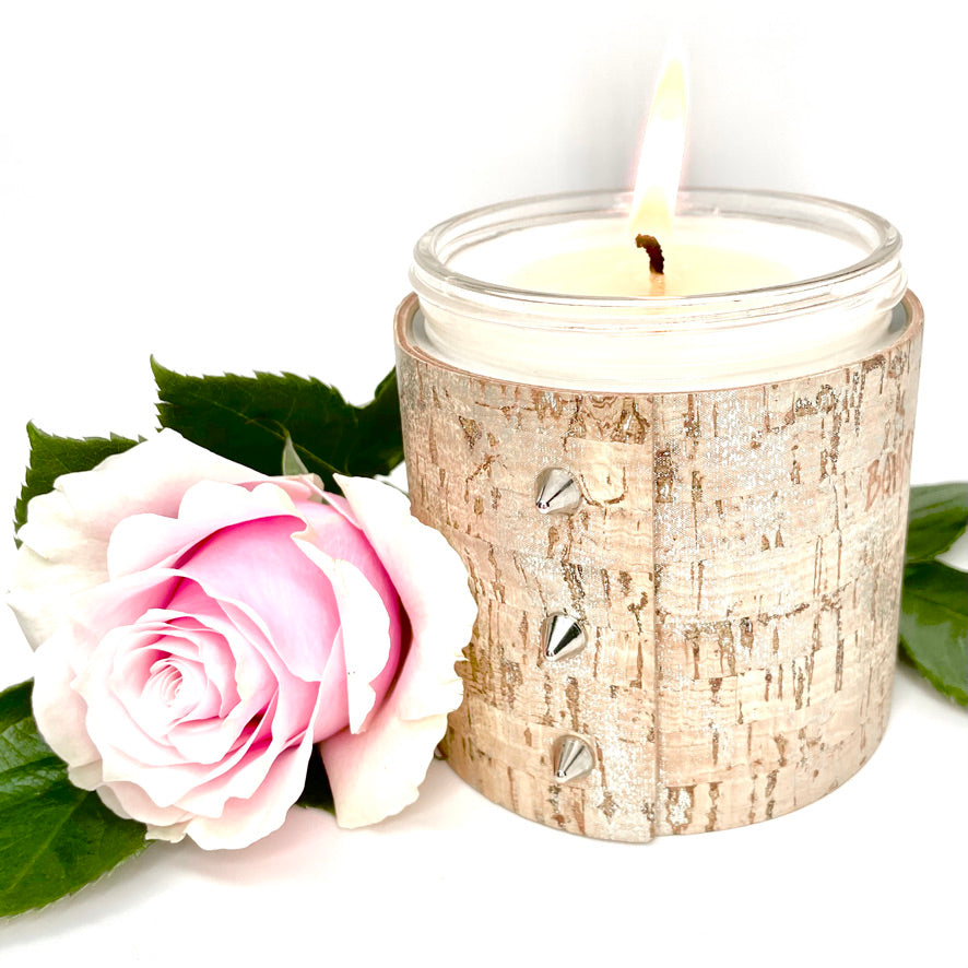 An all natural luxury soy candle wrapped in cork with shimmering silver glaze and 3 shiny silver cone shaped studs