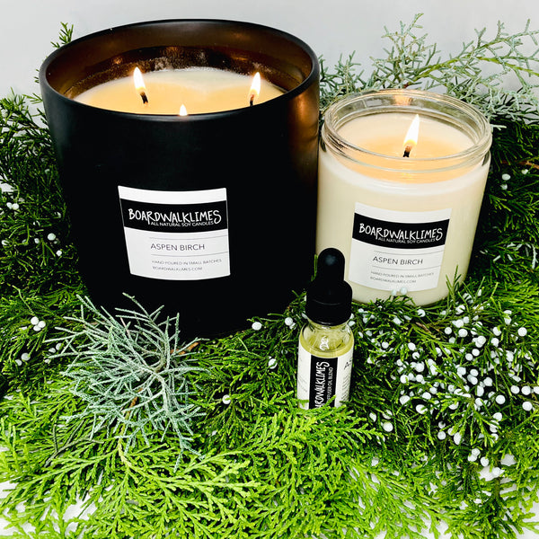 Luxury soy candle in beautiful Aspen Birch evergreen and sweet mint fragrances and an essential oil diffuser oil in rich evergreen
