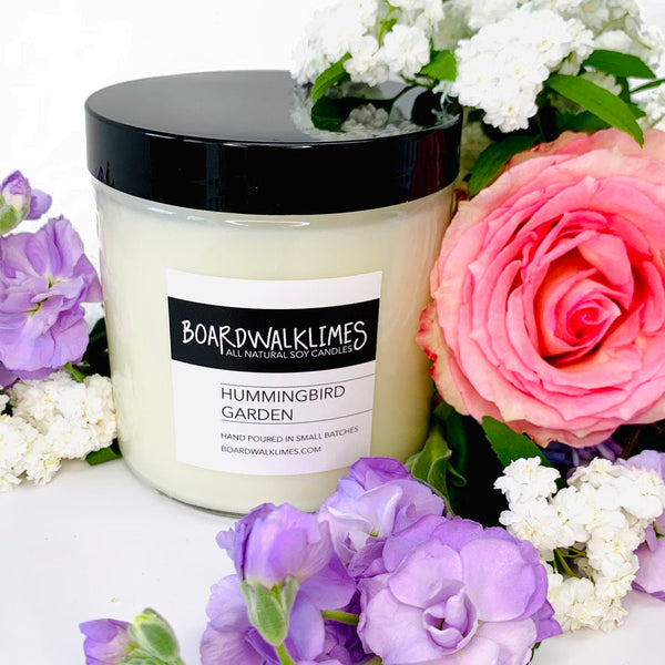 Luxury floral scented soy candle in a clear glass jar with fragrances of rose, lilac, and gardenia fragrances