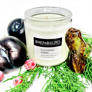 Luxury soy candle scented in blackened amber with plum, amber, and evergreen notes