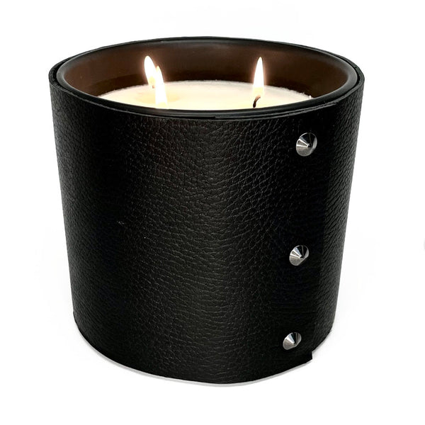large all natural soy candle with 3 wicks is wrapped in a rich black leather with 3 black cone shaped studs