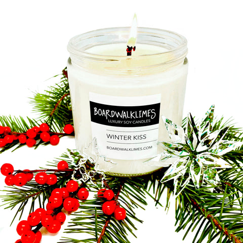 The best winter scented all natural soy candle is rich with pine and tart berries in a clear glass jar