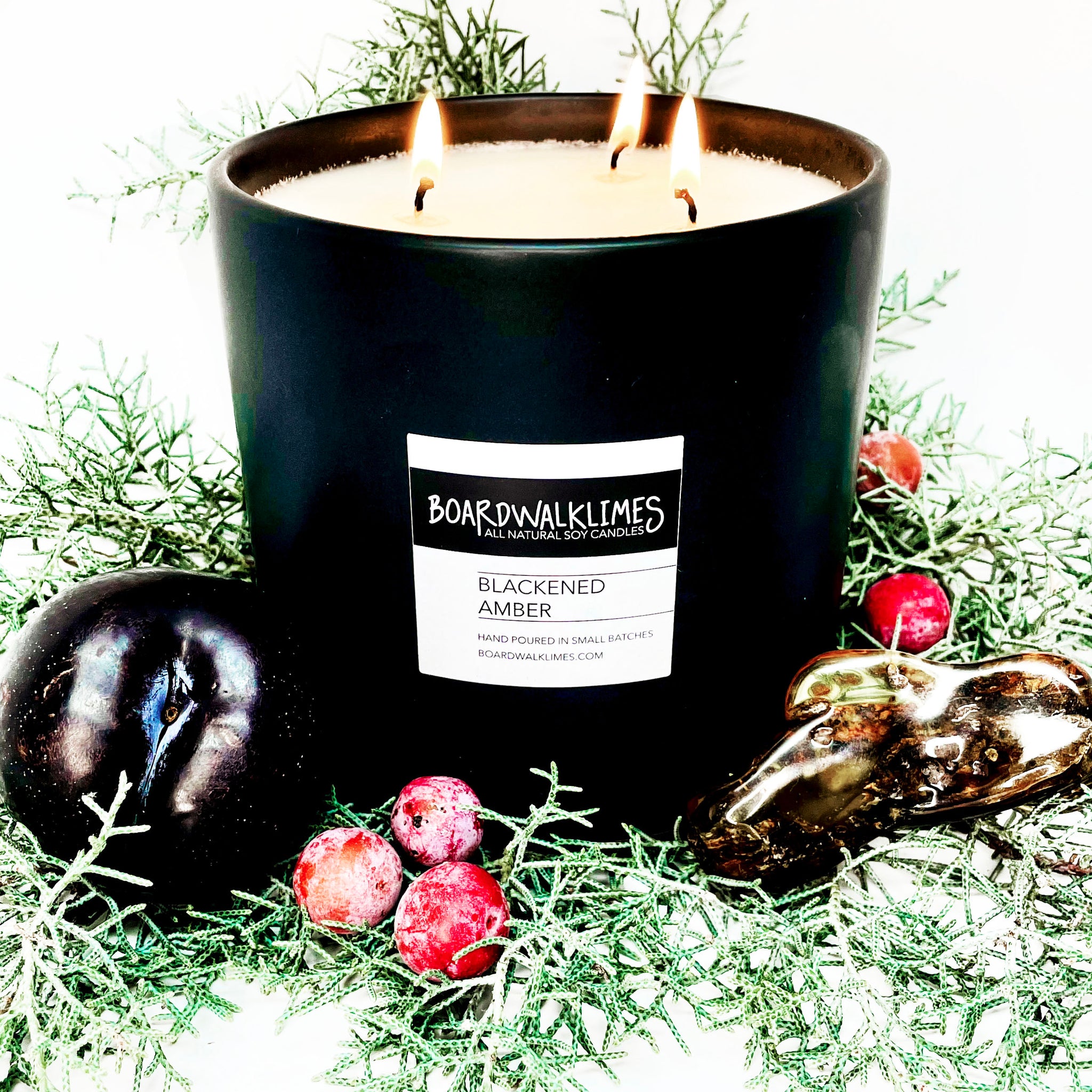 Luxury large 3 wick soy candle scented in blackened amber with plum, amber, and evergreen notes