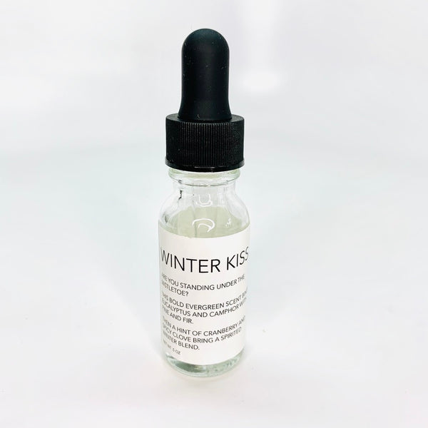 Diffuser oil blend in winter scents in a glass Boston round bottle with a black dropper lid.