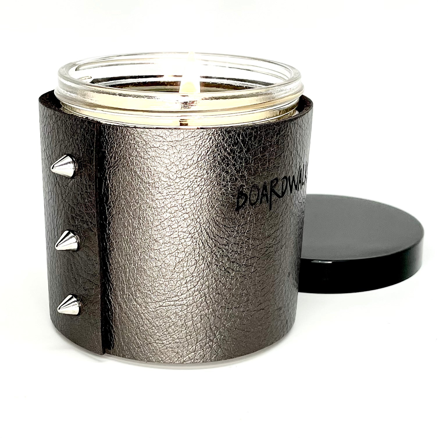 Luxury all natural soy candle in a metallic leather in gunmetal grey with 3 shiny silver cone shaped studs