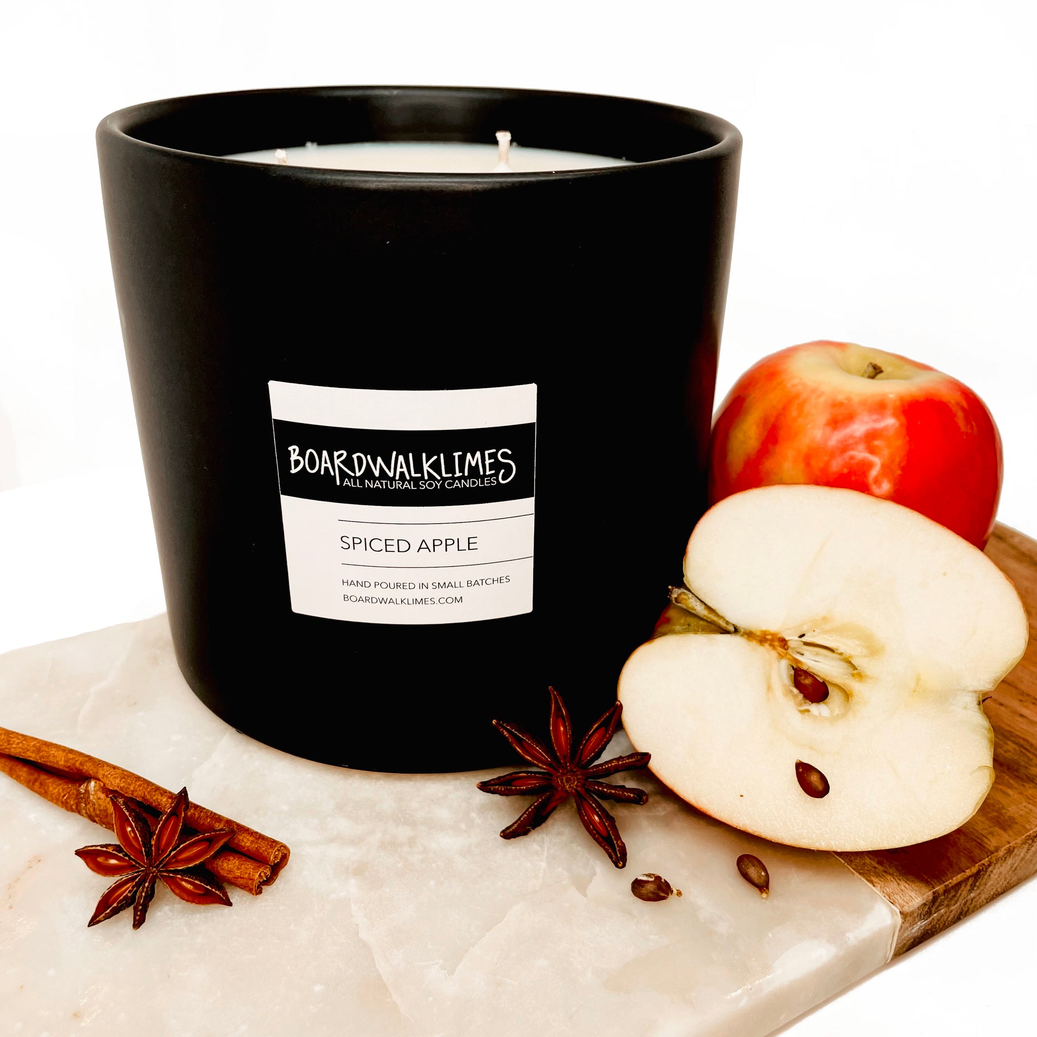 Luxury large fall scented soy candle with 3 wicks in a handmade black ceramic vase with apples and spiced and cinnamon