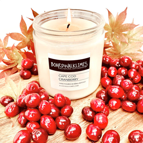 Luxury fall scented soy candle that smells like cranberries in a clear glass jar with a cotton wick