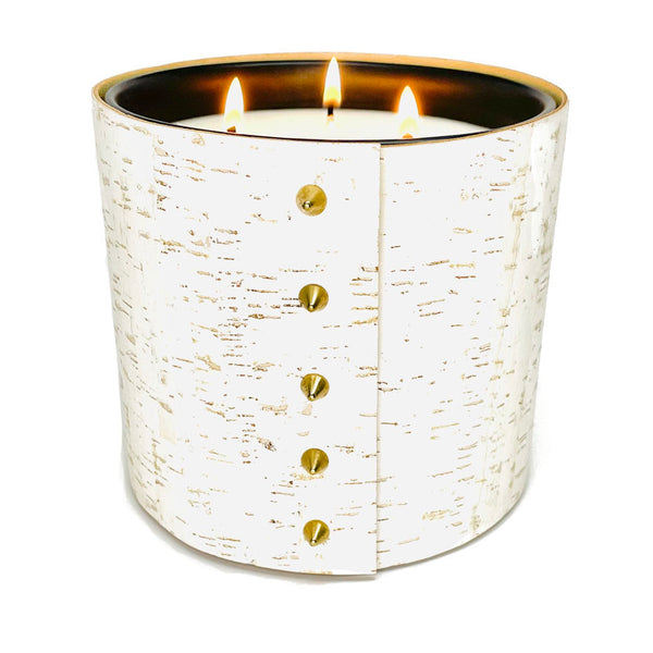 An all natural luxury soy candle wrapped in white cork with and 5 gold cone shaped studs