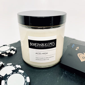 Luxury masculine bourbon and spiced honey and smoke scented soy candle in a clear glass jar with a shiny black lid